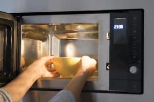 Woman heating food at microwave